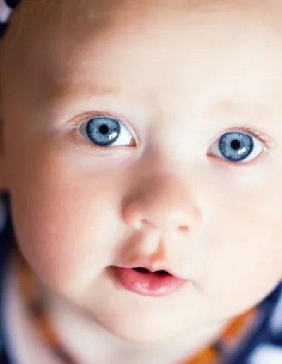 Close-up portrait of a baby with bright blue eyes