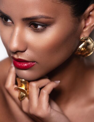 Beauty close-up portrait with red lipstick and gold jewellery