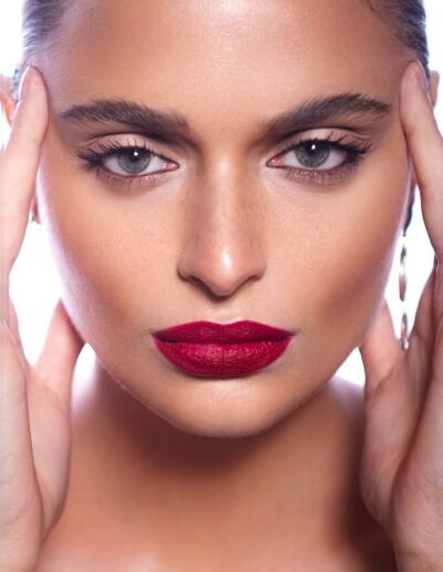 Close-up beauty portrait with red lipstick and natural eye makeup