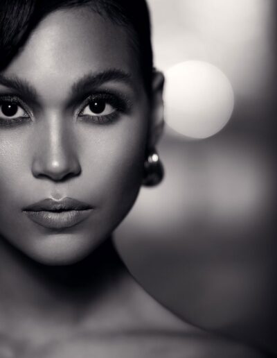 Black and white close-up beauty portrait with dramatic eye makeup