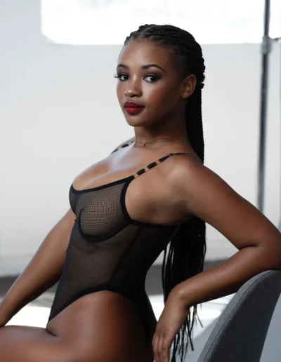Woman in black lingerie posing for a boudoir portrait