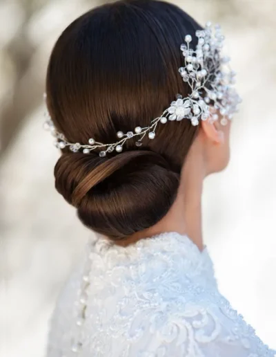 Brunette bridal low bun with pearl and crystal hair accessory