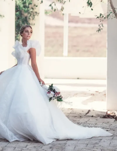 Bride holding a large white floral bouquet in a close-up portrait