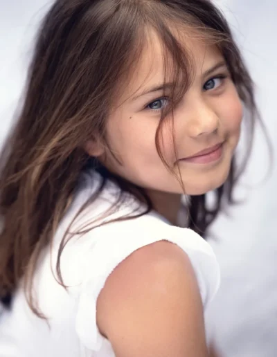 Brunette girl smiling over her shoulder during a portrait photoshoot