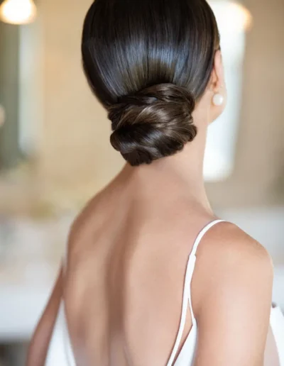 Sleek brunette low bun with woven hair detail