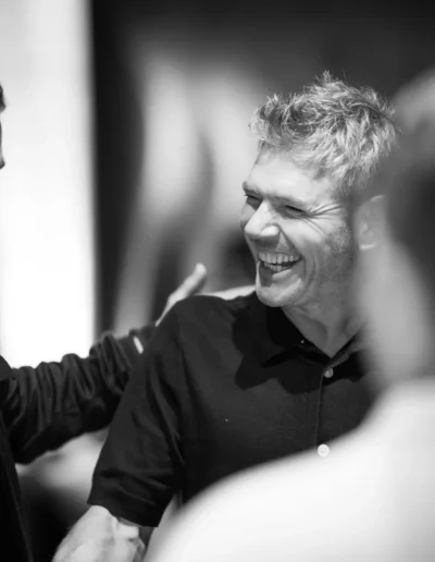 Smiling guest photographed candidly at a private event