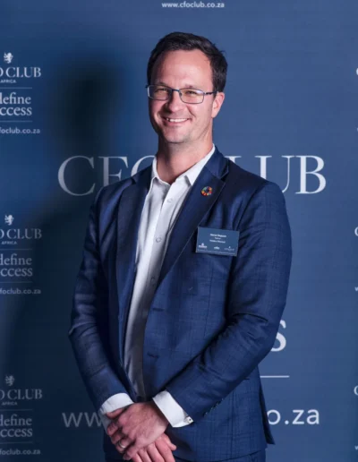 Professional man in a blue suit photographed at a corporate event