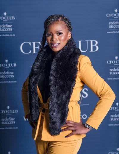 Businesswoman in a yellow suit photographed at a corporate event