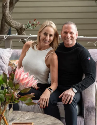 Smiling couple seated together during an outdoor portrait session