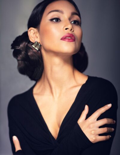 Woman with sculpted dark hairstyle in an editorial beauty portrait