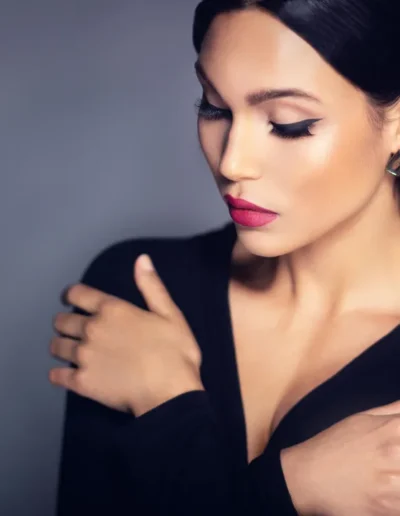Editorial makeup with winged eyeliner and bold pink lips