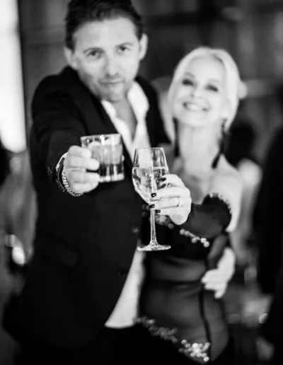 Guests raising their drinks for a toast at a private event