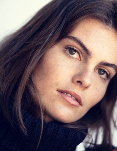 Natural light portrait of a brunette woman with freckles
