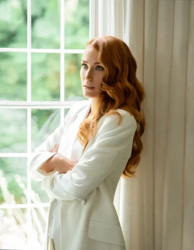 Long red hair styled in glamorous soft Hollywood waves
