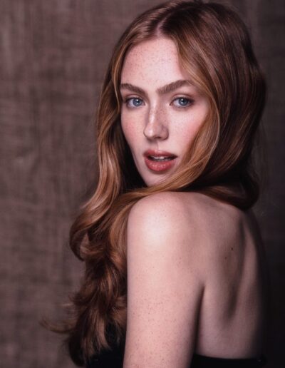 Red-haired woman with freckles in an editorial studio portrait