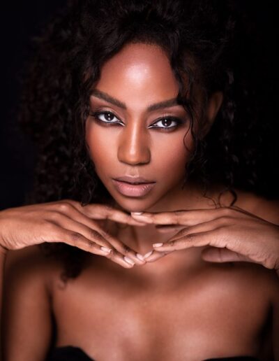 Studio beauty portrait with curly hair and soft neutral makeup